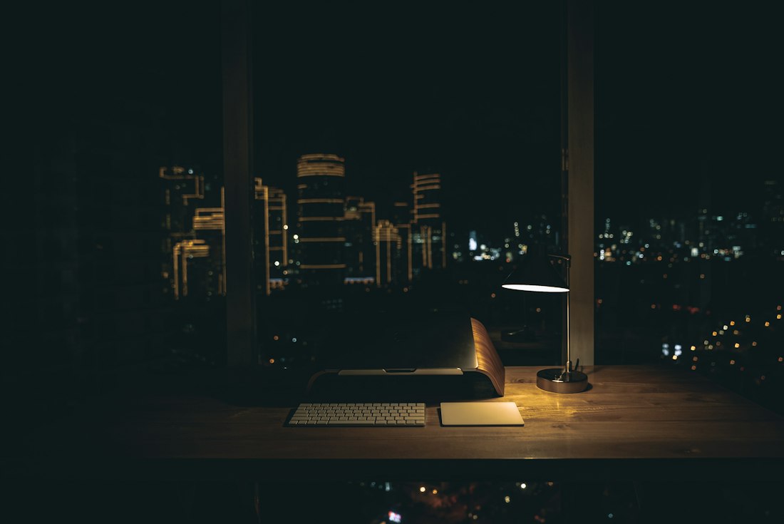 An office at night with the city glowing outside